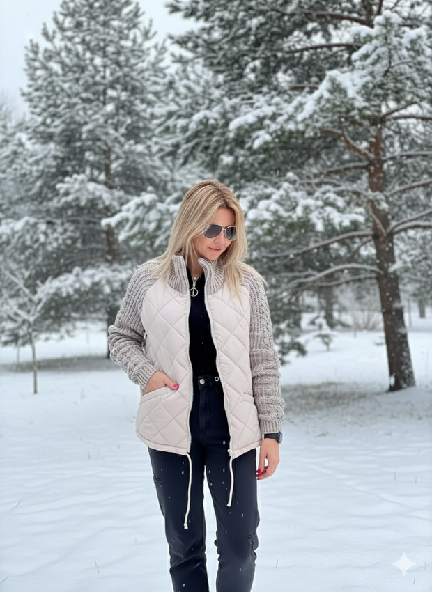 Quilted puffer vest and knitted sweater combo on woman in snowy park.