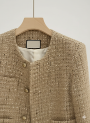 Close-up of the luxurious tweed fabric and ornate gold button detail on the VYRO Elegant Tweed Cropped Jacket.